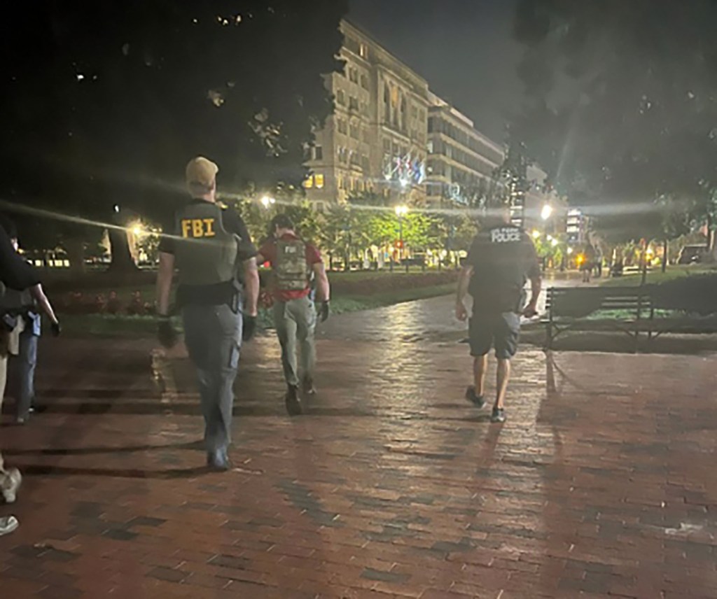 FBI and Park Police officers walking at night in Washington, DC.