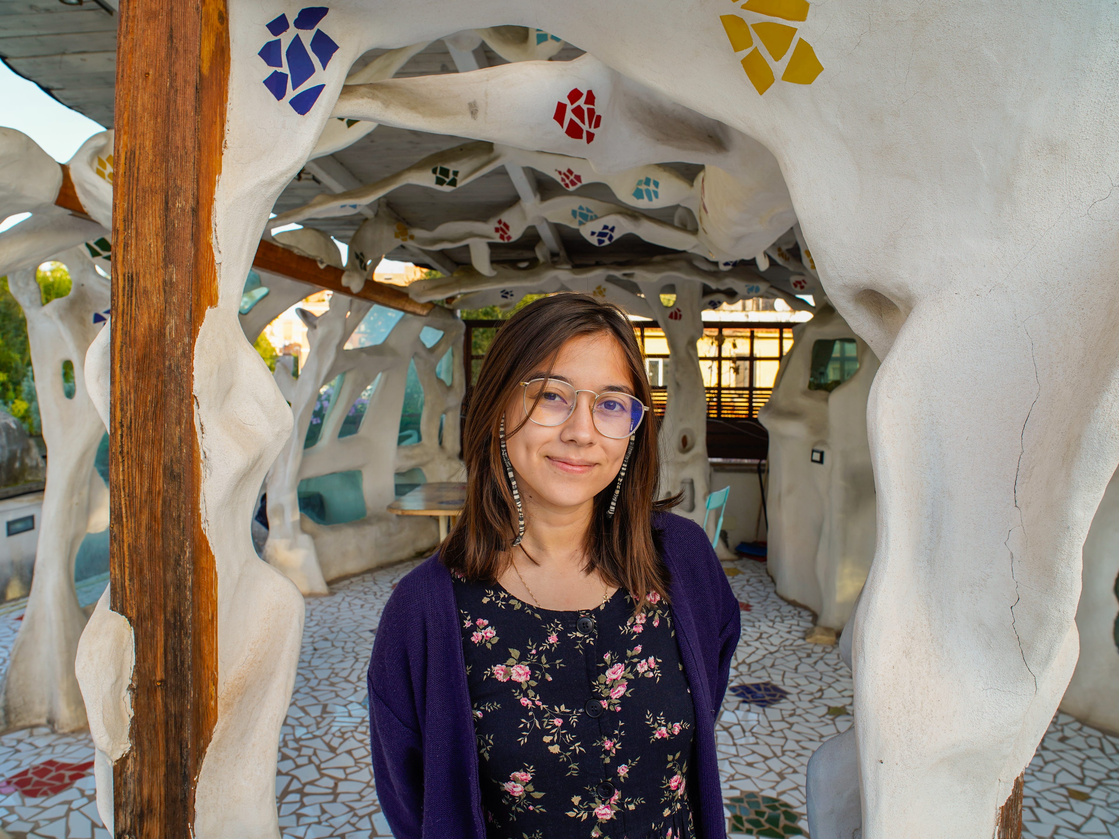 The author stands in front of a colorful sculpture Airbnb in Rome