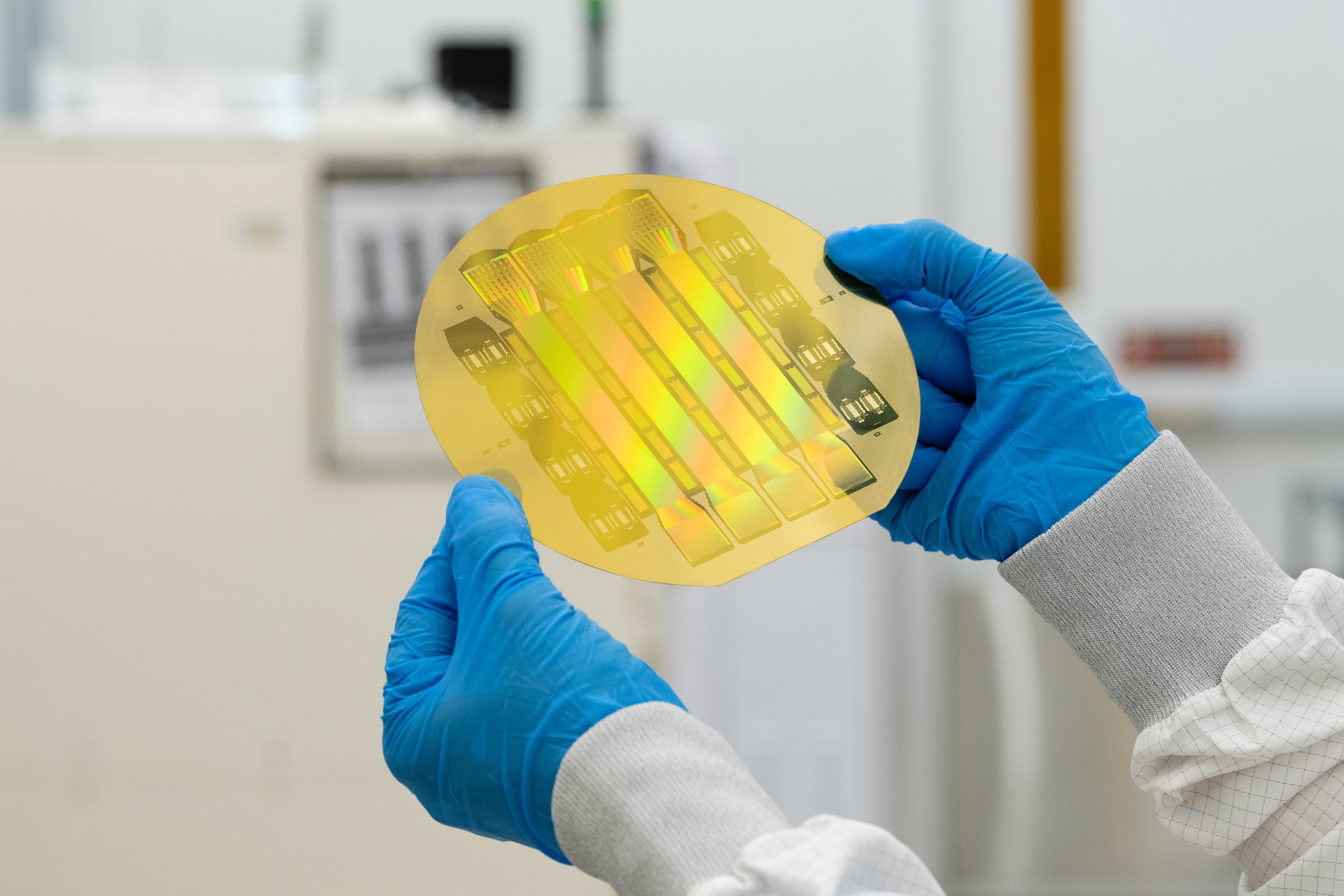 A Precision Neuroscience researcher holds the product, a thin film that sits on the top of the brain.