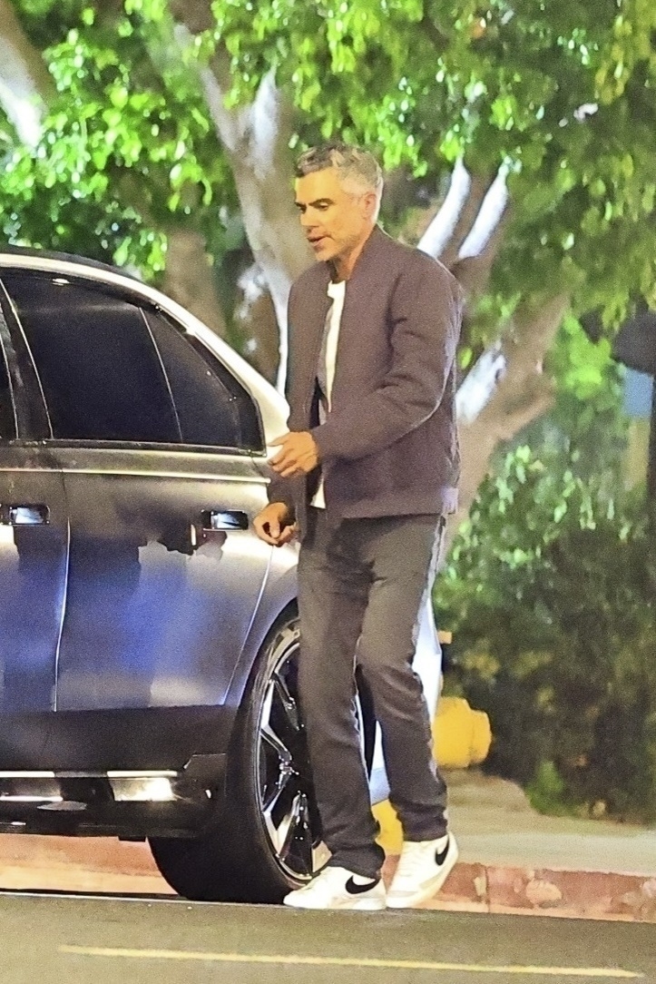 Cash Warren in a jacket by a car. 