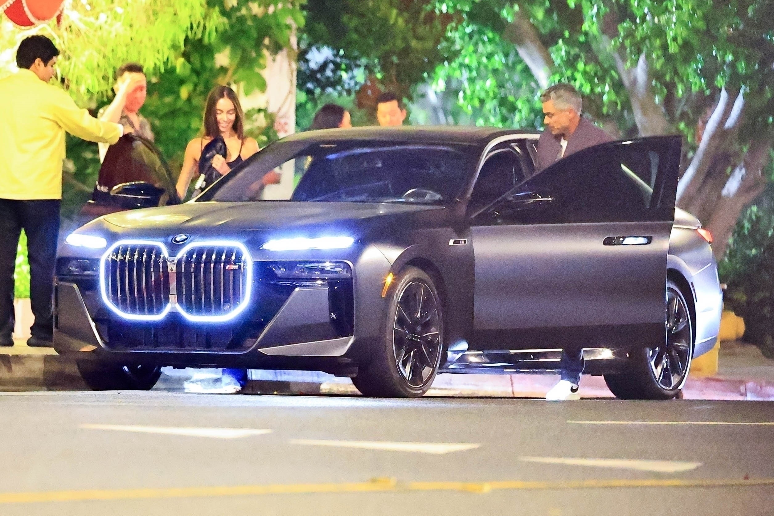 Hana Sun Doerr steps into a BMW at night. 