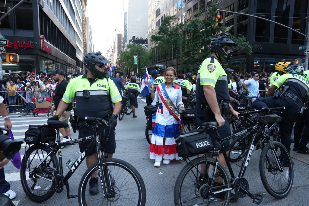 Members of the New York City Police Department perform crowd control as spectators overflowed onto the path of the parade during the National Dominican Day Parade on Sunday, August 11, 2024 in New York, N.Y. 