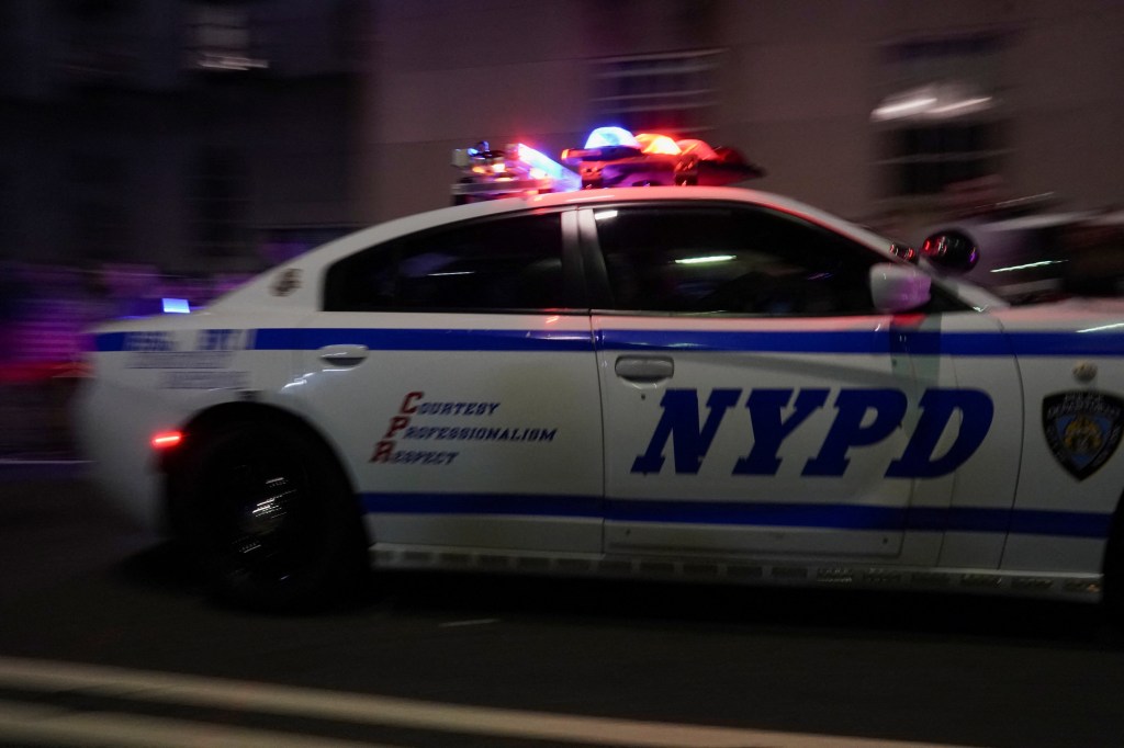 NYPD car escorting ambulance.