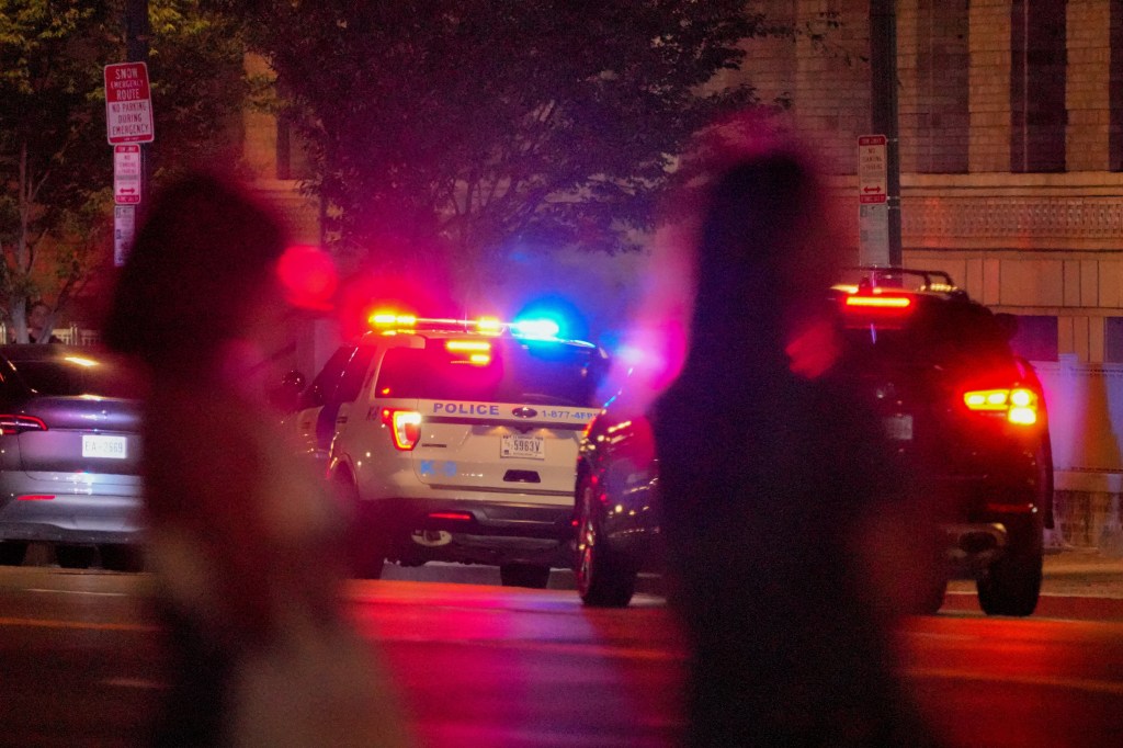 Police cars with flashing lights at night in Washington, D.C.