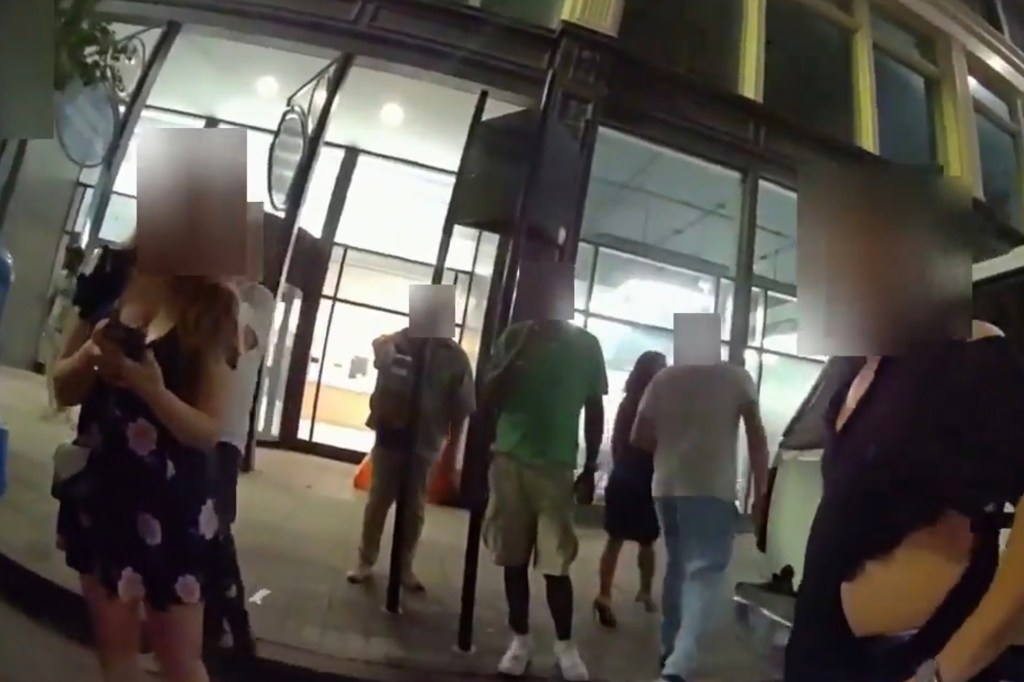 Bodycam footage of a group of people outside a building at night.
