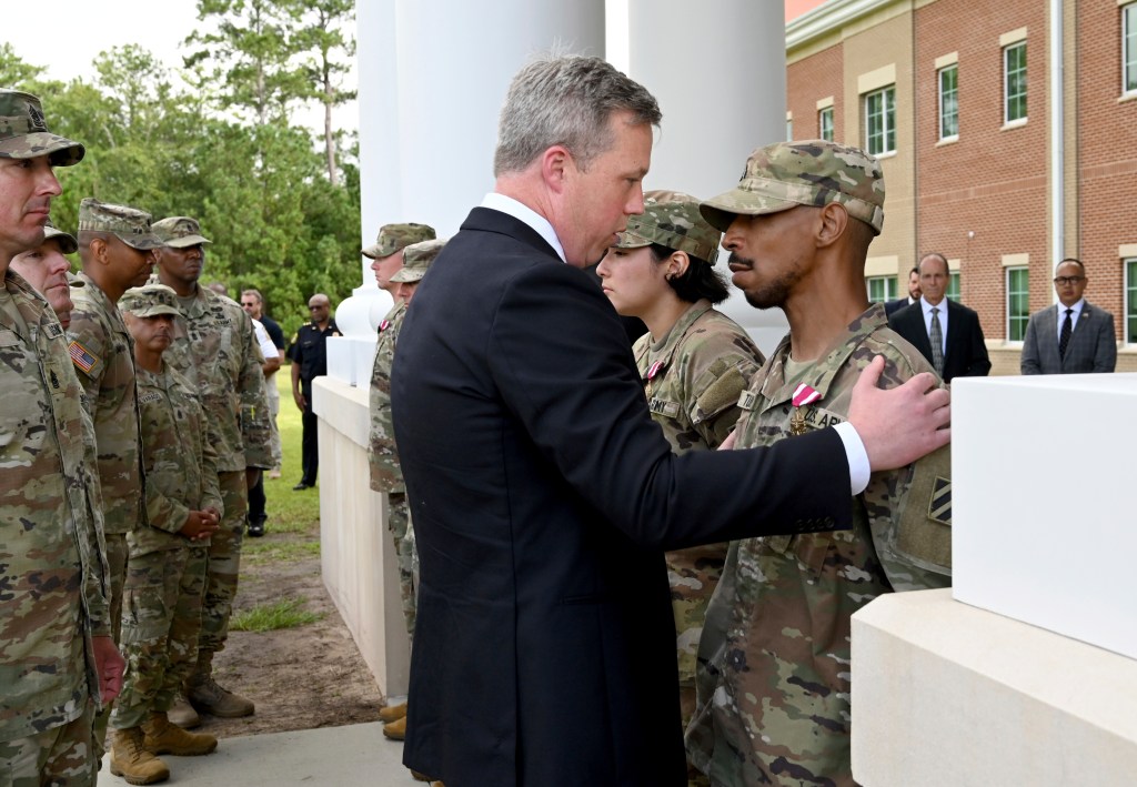 Army Secretary comforting soldier at Fort Stewart.