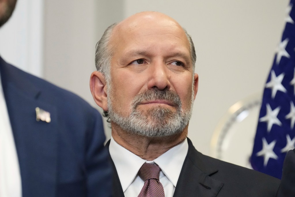 Howard Lutnick listening to Donald Trump.