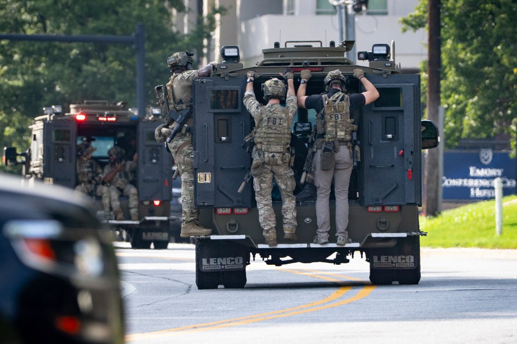 FBI agents in armored vehicles at Emory University.