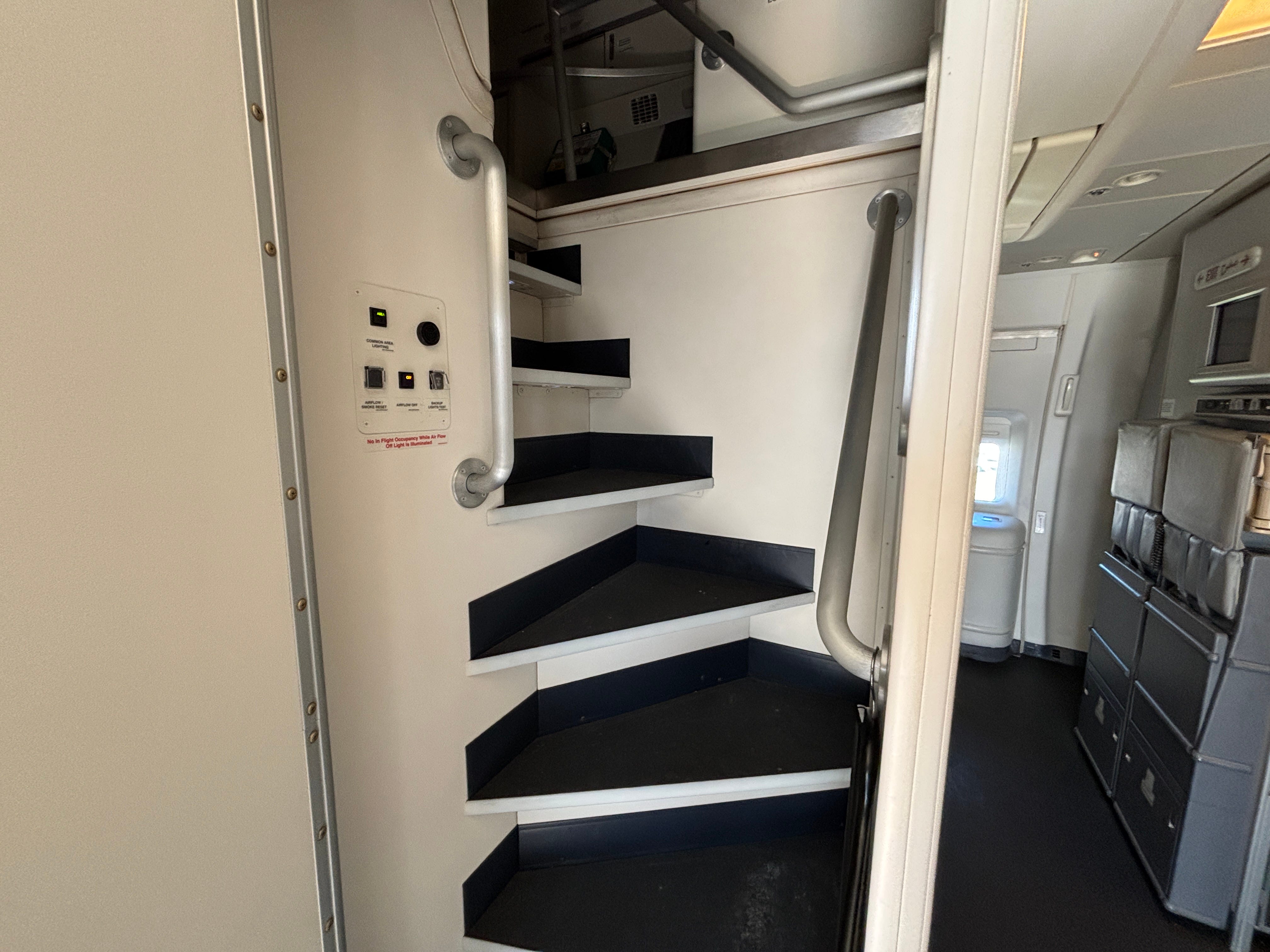 The stairs leading up to the crew rest area on a Boeing 777-300ER