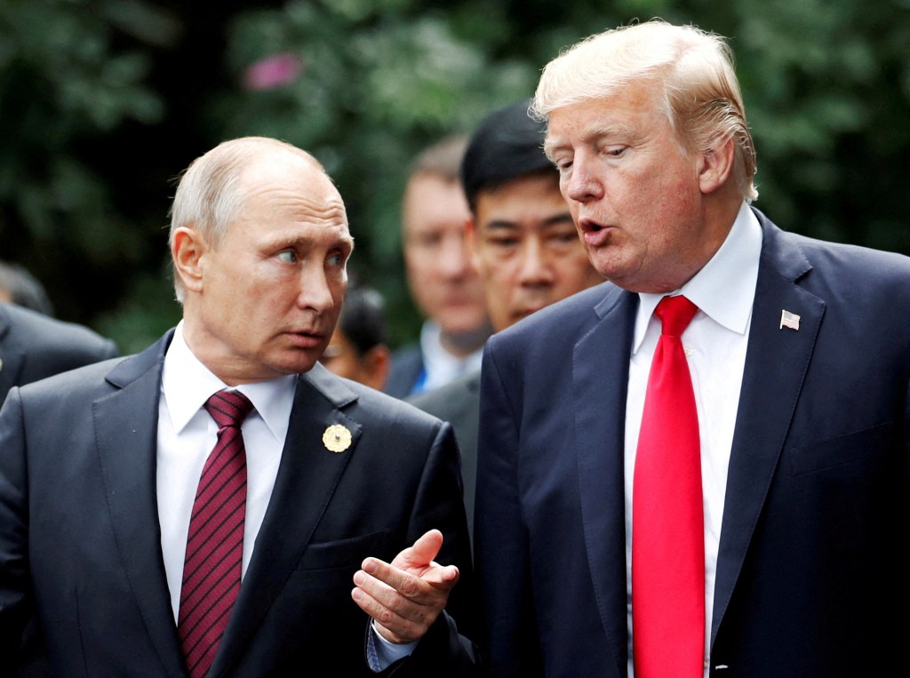 President Donald Trump and Russian President Vladimir Putin talk during a photo session at the APEC Summit in Danang, Vietnam, on Nov. 11, 2017.