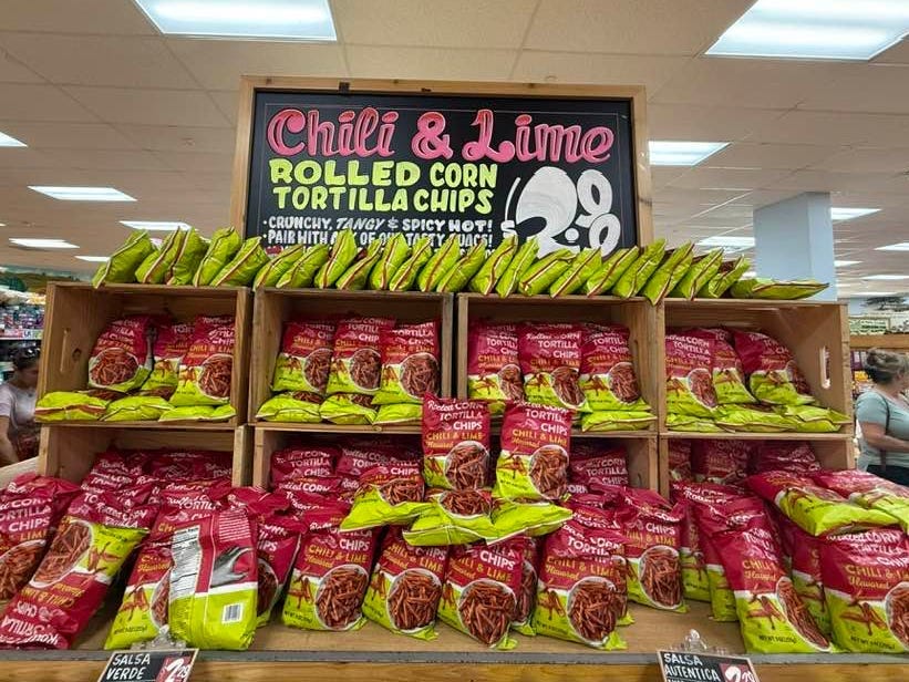Trader Joe's chili and lime rolled corn tortilla chips on display in the store.