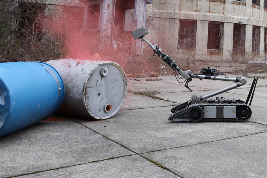 NYPD bomb disposal robot detonating a barrel.