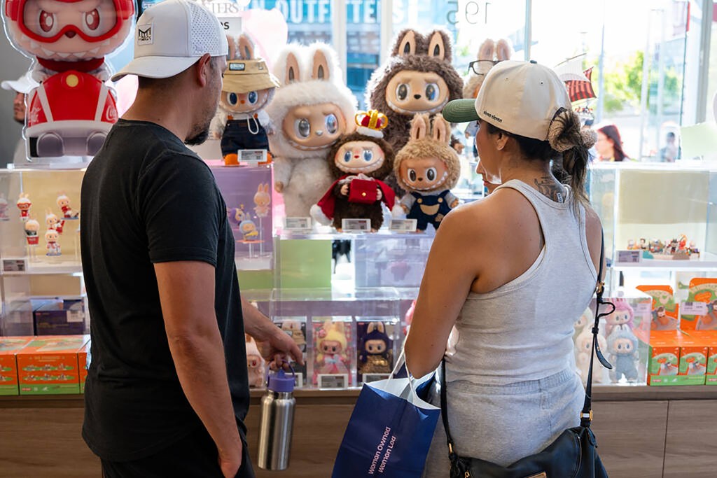 Couple looking at Labubu dolls in a Pop Mart store.
