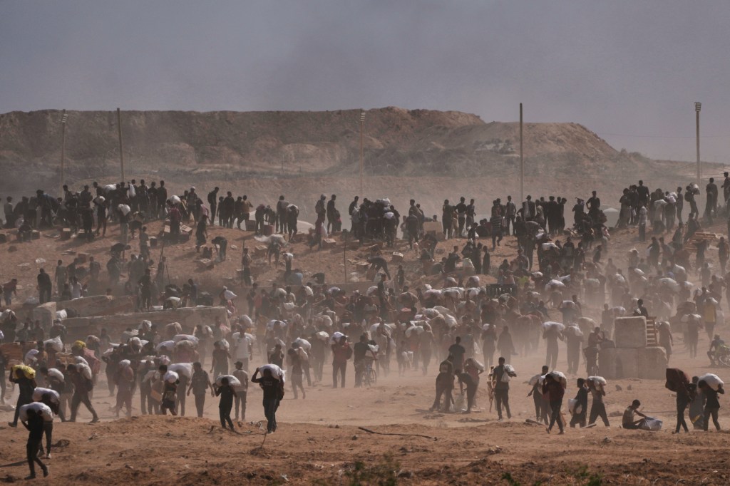 Palestinians carrying humanitarian aid in Gaza.