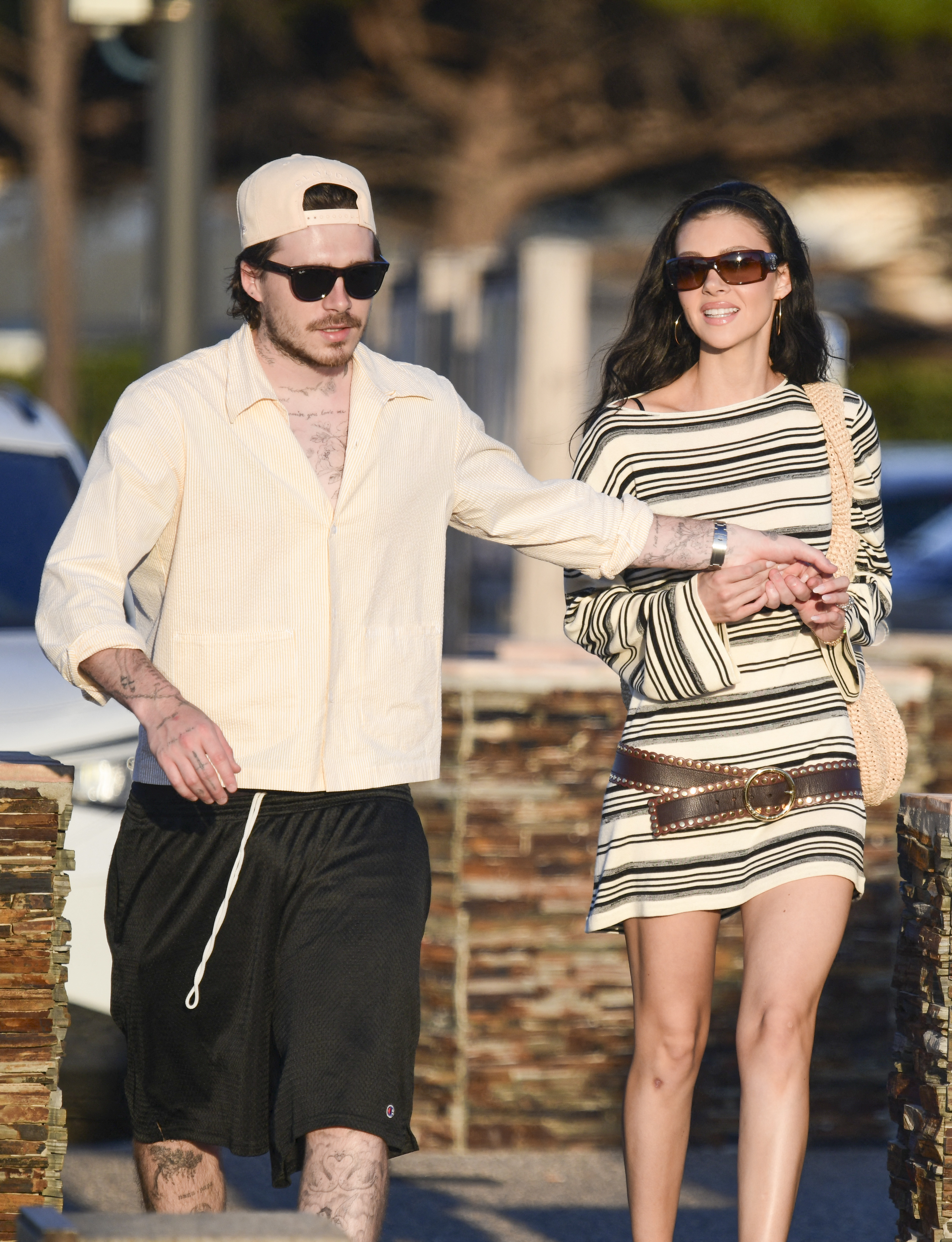 Nicola Peltz and Brooklyn Beckham hold hands. 
