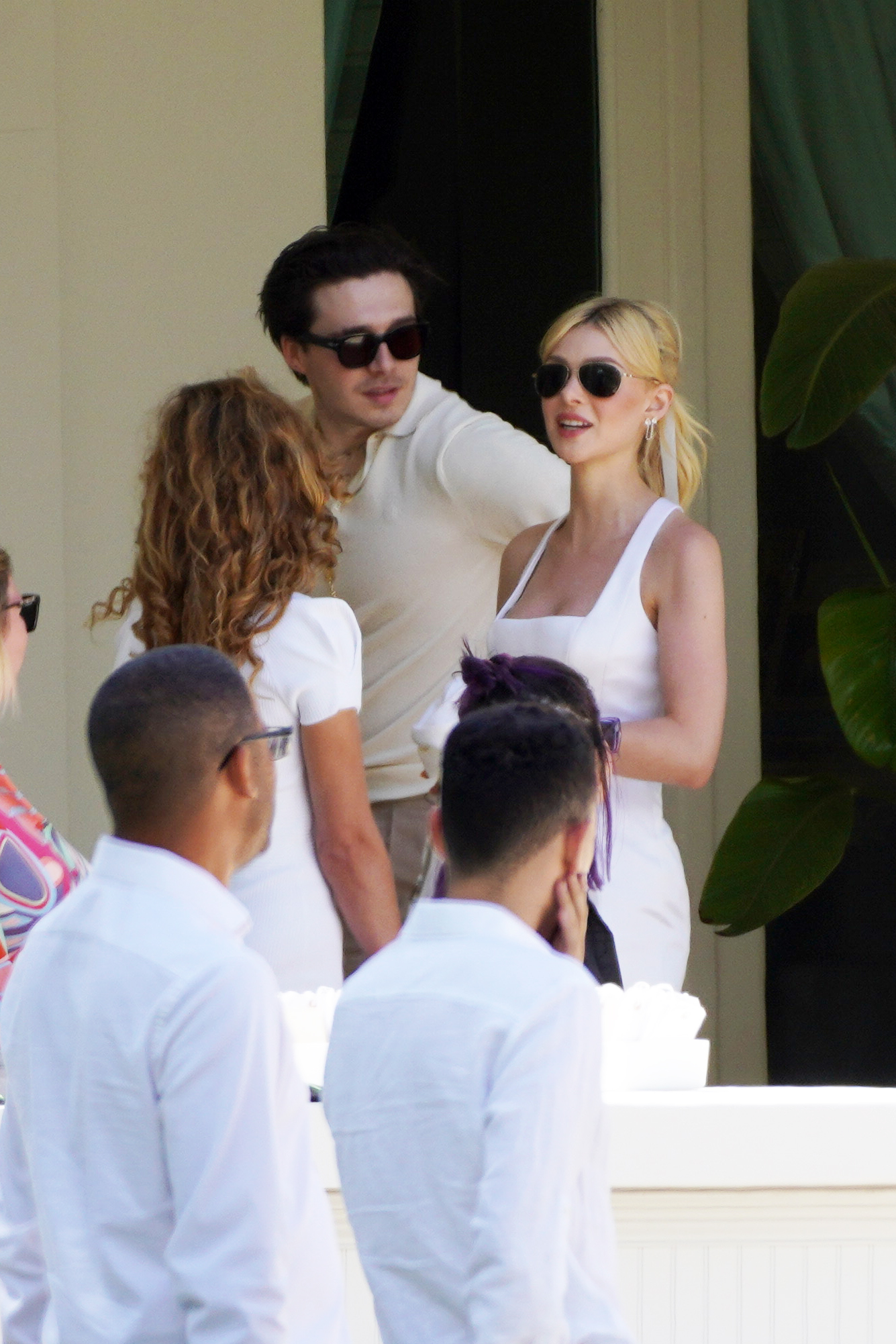 Brooklyn Beckham and Nicola Peltz in white. 