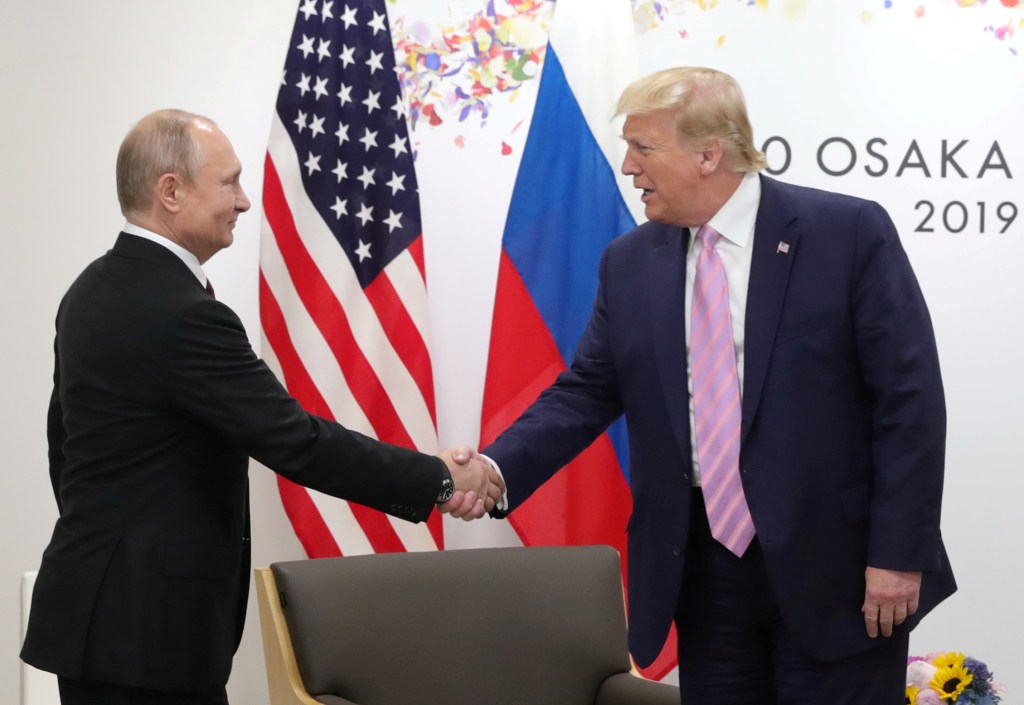 Vladimir Putin and Donald Trump shaking hands at the G20 summit.