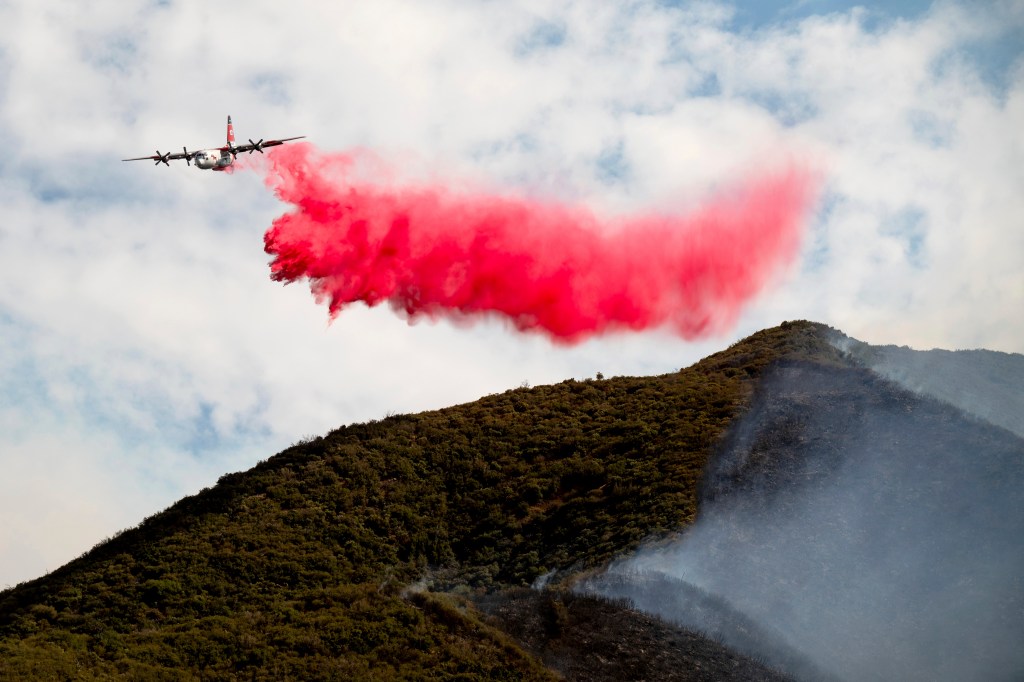 Air tanker dropping fire retardant on a wildfire.