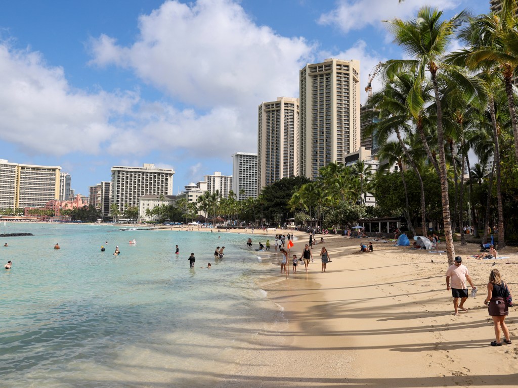 Beachgoers at Waikiki Beach after a tsunami warning was downgraded.