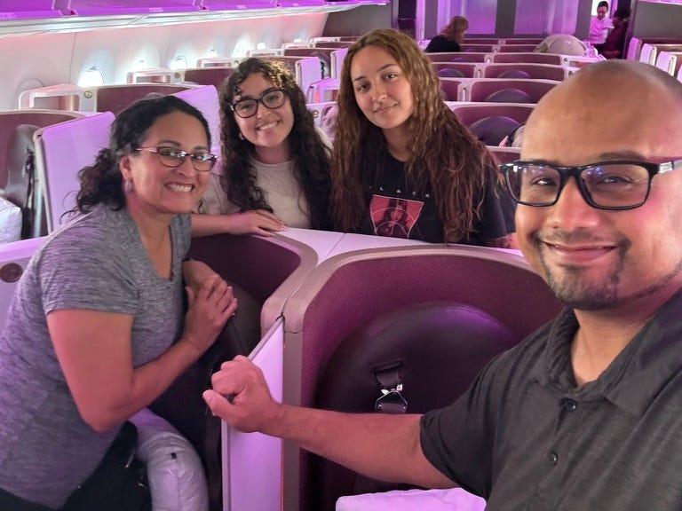 author, kimanzi , and his family taking a selfie on a first class flight