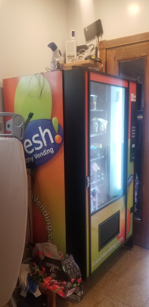 Vending machine in a corner of a room.
