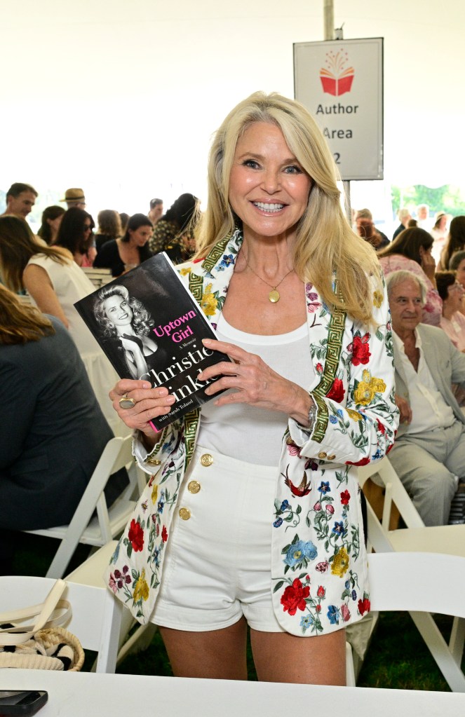 Christine Brinkley holding up her memoir.