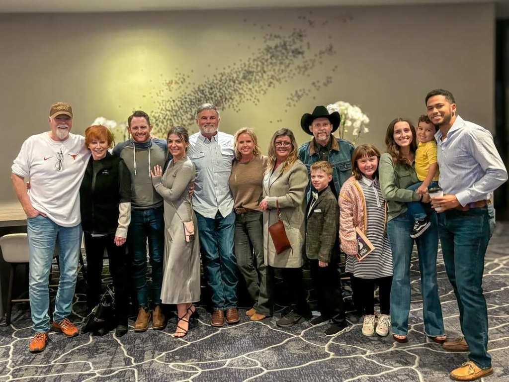 Reba McEntire and Brandon Blackstock pose in a group.