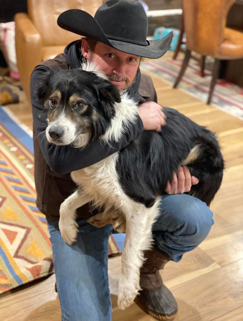 Brandon Blackstock poses with a dog.