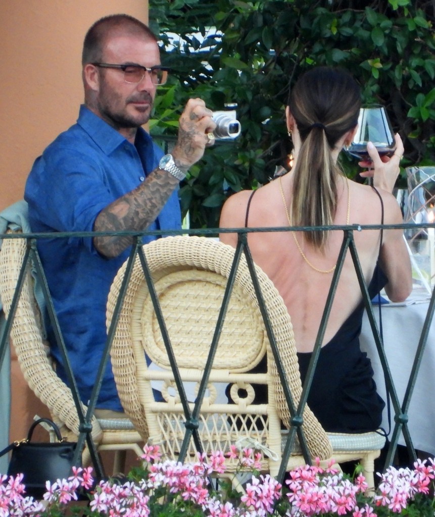 David Beckham taking a photo of  Victoria Beckham in Italy.