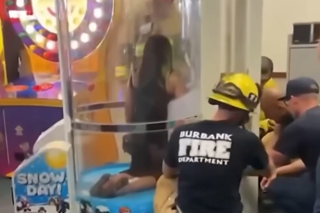 Firefighters rescue a woman stuck in a Chuck E. Cheese arcade game.