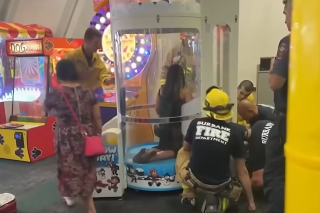 Firefighters rescue a woman stuck in a Chuck E. Cheese arcade game.