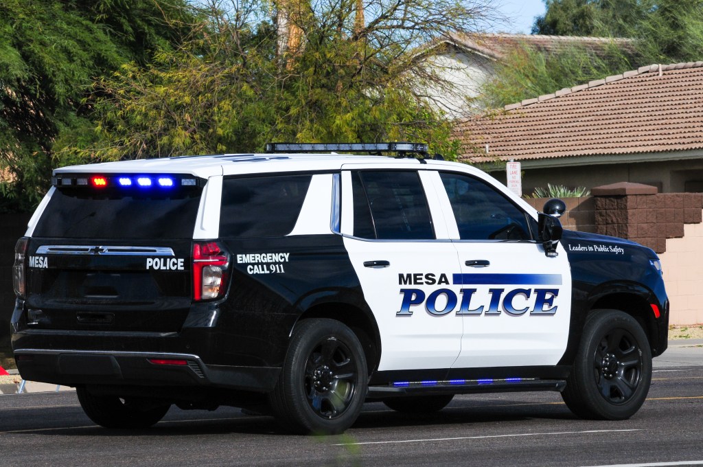Mesa Police Department SUV with emergency lights flashing.
