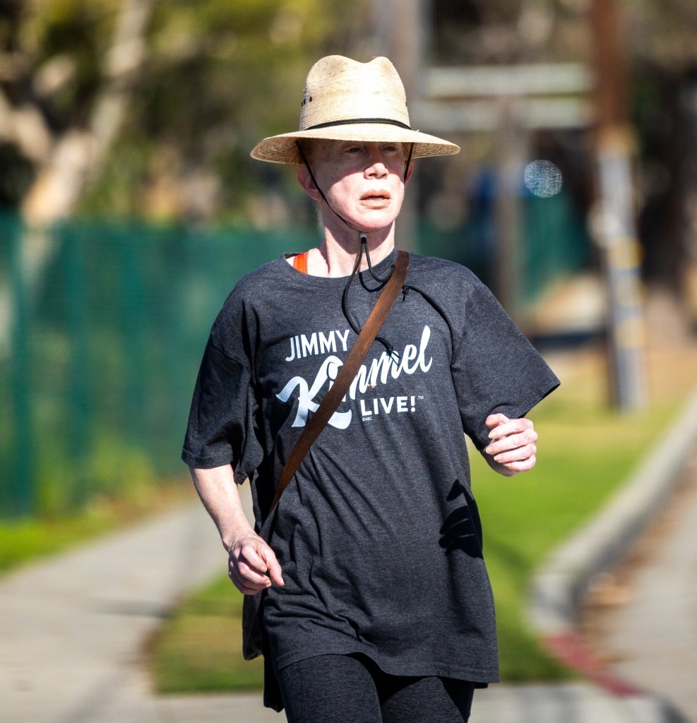 Kathy Griffin on a walk wearing a hat.