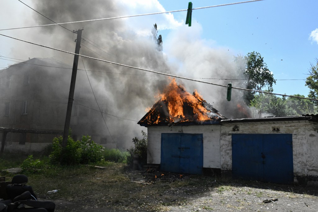 Burning building following a drone strike in Bilozerske, Donetsk region.