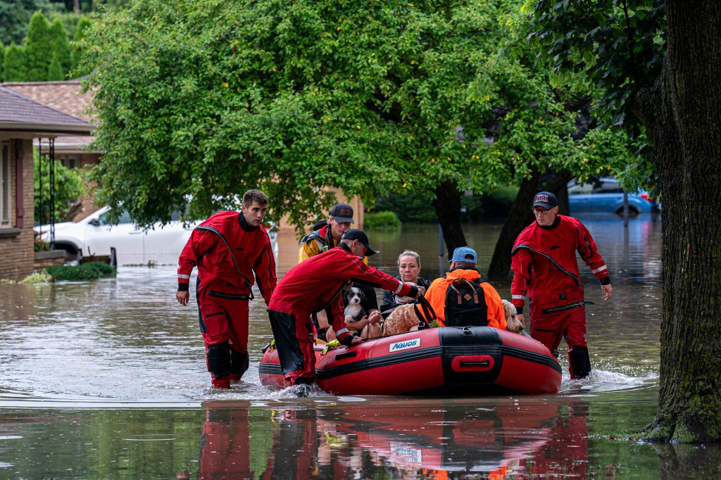 First responders rescue people from flooding in their homes on August 10, 2025 in Wauwatosa, Wisconsin. 