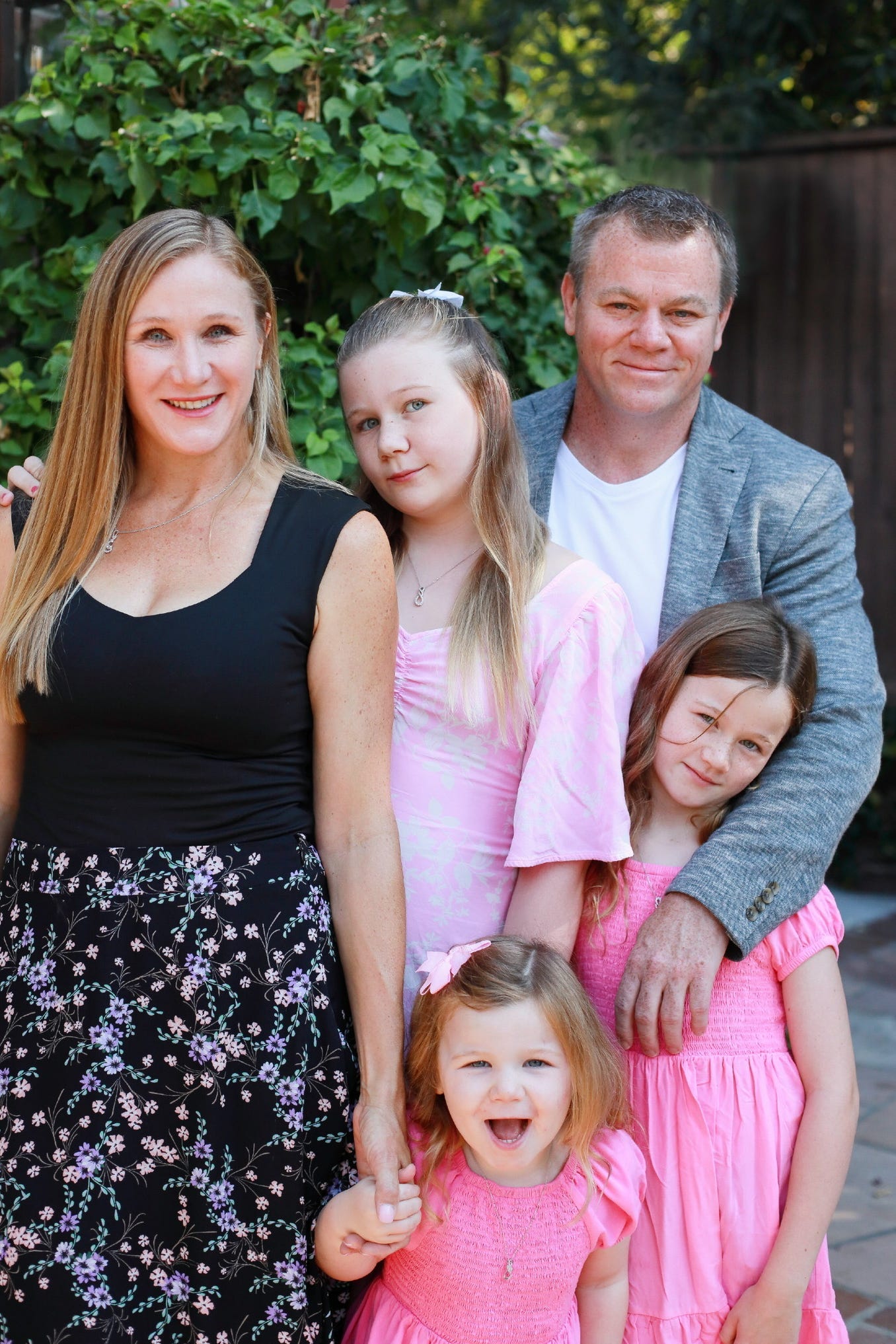 a family of 5 poses for a photo