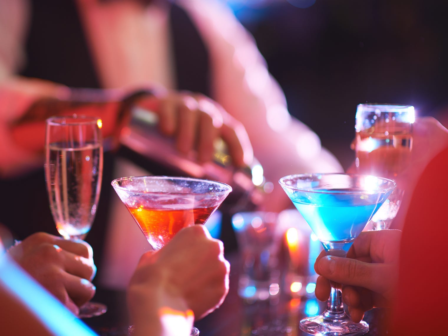 People at bar with cocktails