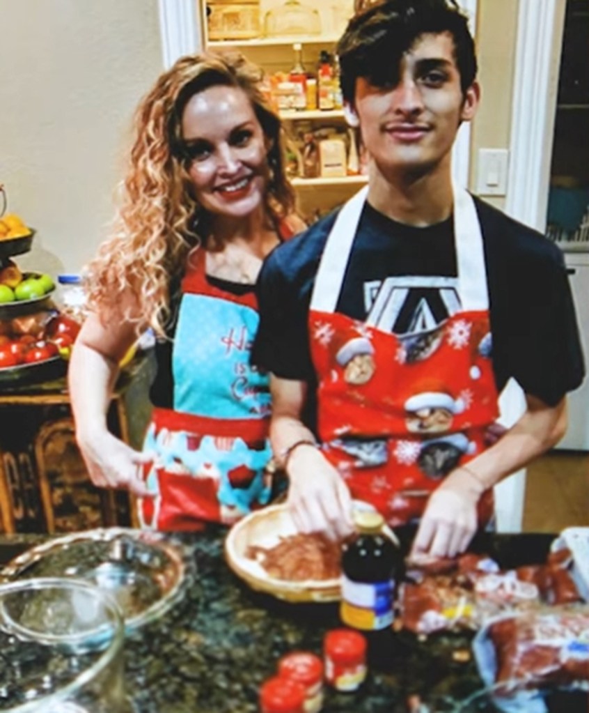 Photo of a mother and son wearing aprons in a kitchen.