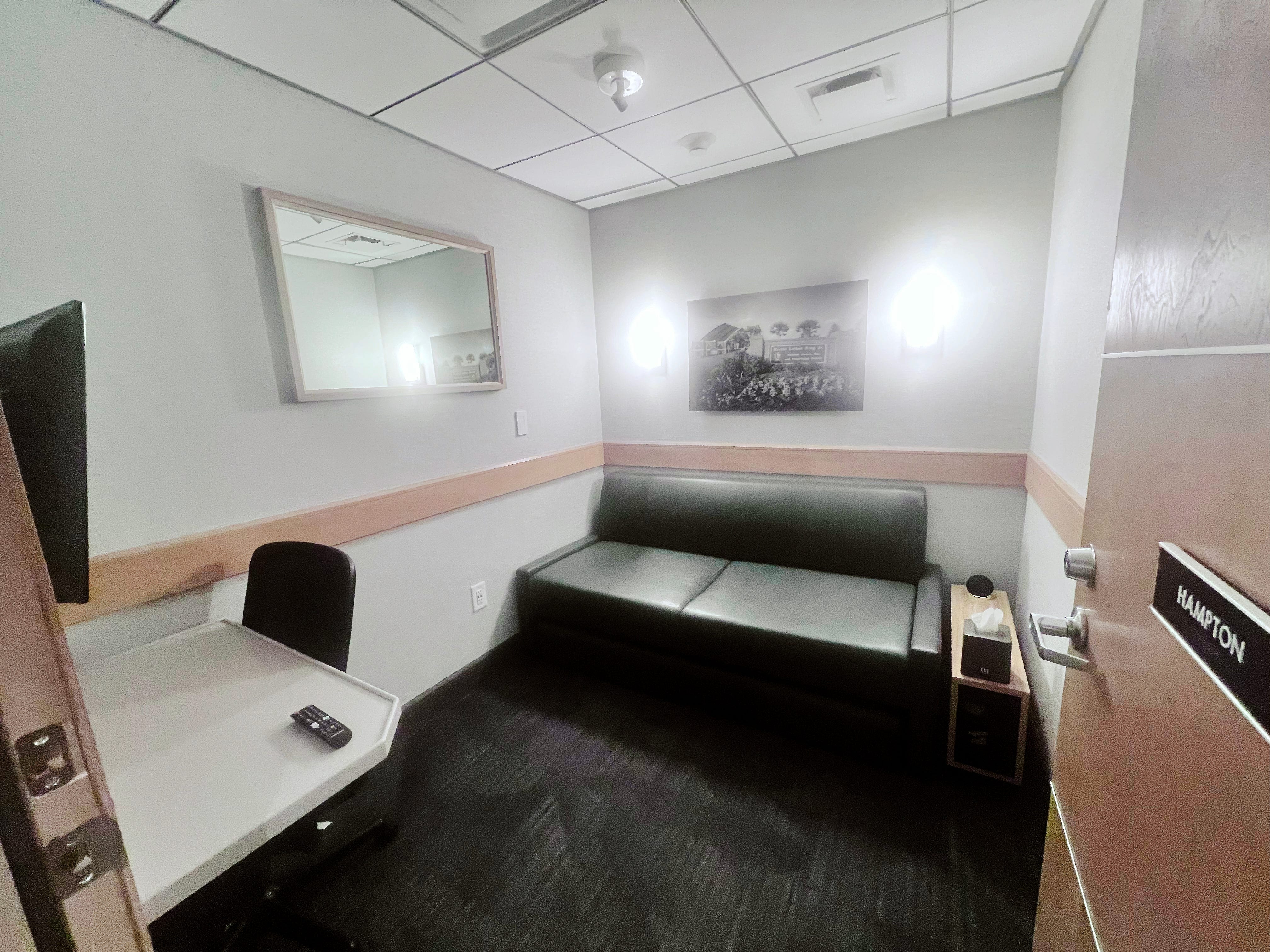 Minute Suites with desk, couch, table, lights