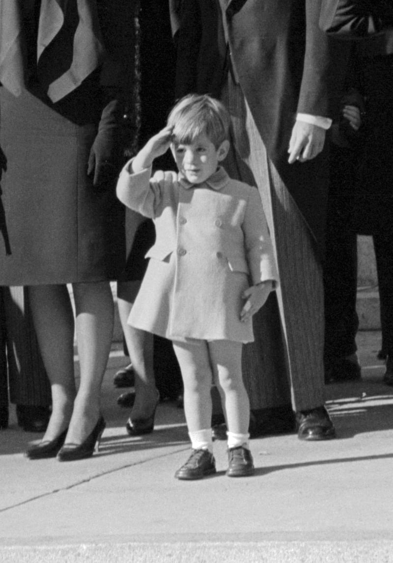 John F. Kennedy Jr., who turns three today, salutes as the casket of his father, the late President John F. Kennedy, is carried from St. Matthew's Cathedral in Washington, DC.