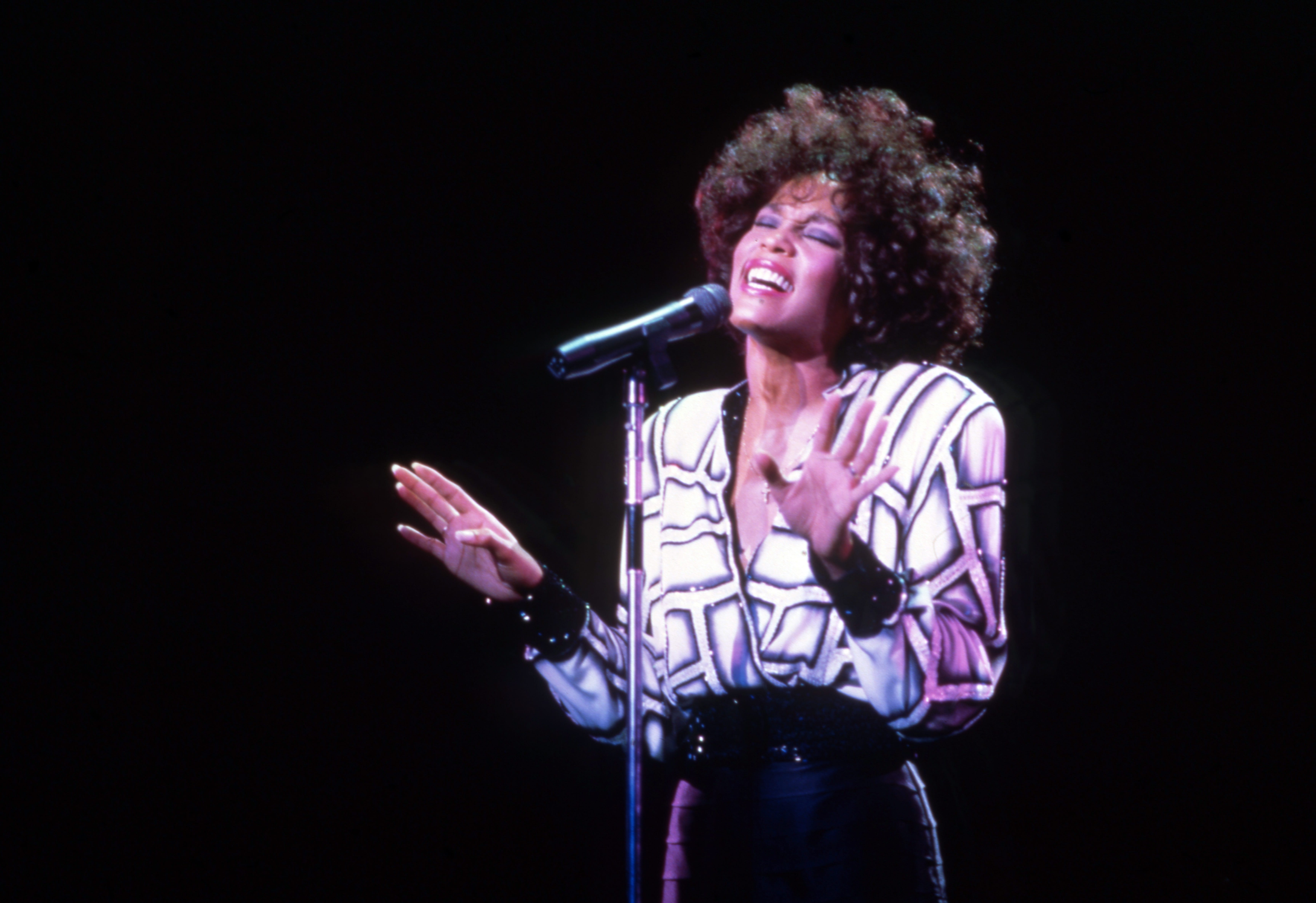 American singer and actress, Whitney Houston, performs at the Pine Knob Music Theater during her "Moment of Truth" world tour, on July 31, 1987
