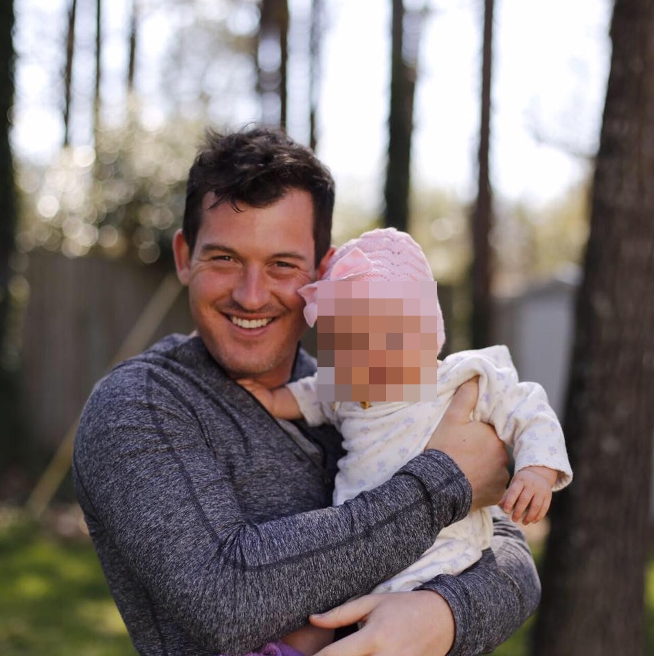 Peter Goodwin, holding a baby.