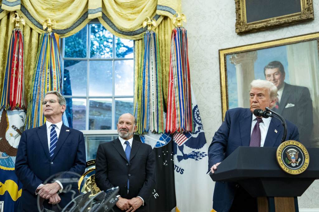 President Trump announces a $100 billion Apple investment in the U.S. with two other men.