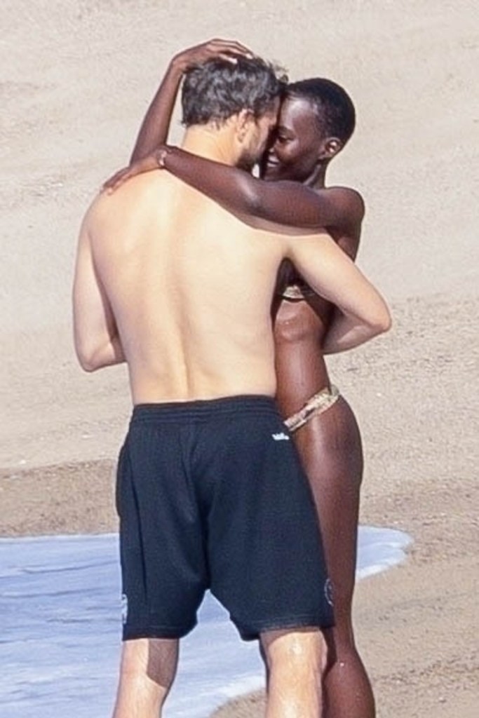 Lupita Nyong'o and Joshua Jackson on the beach