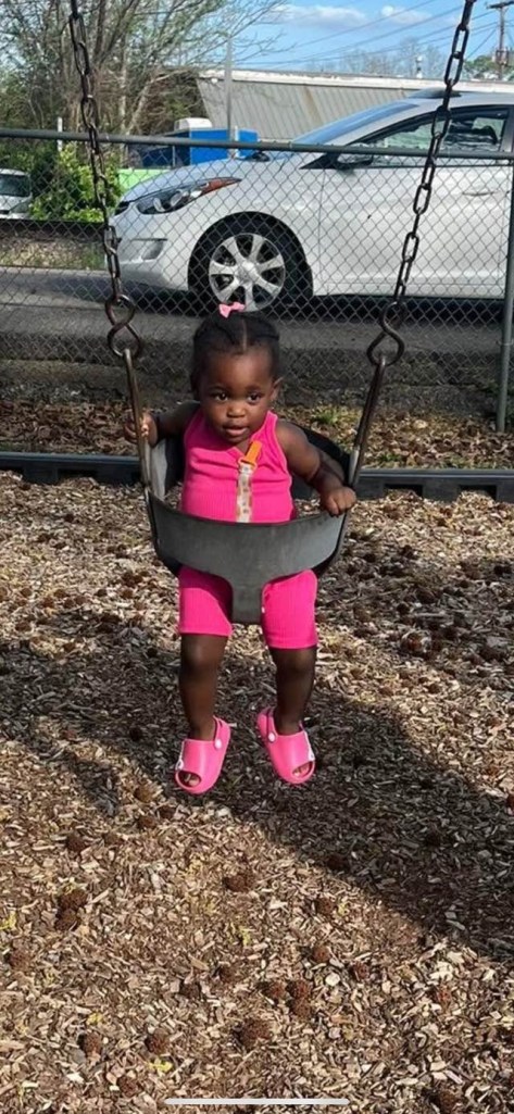 Toddler on a swing set.