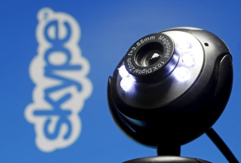 A web camera is seen in front of a Skype logo in this photo illustration taken in Zenica, May 26, 2015. REUTERS/Dado Ruvic