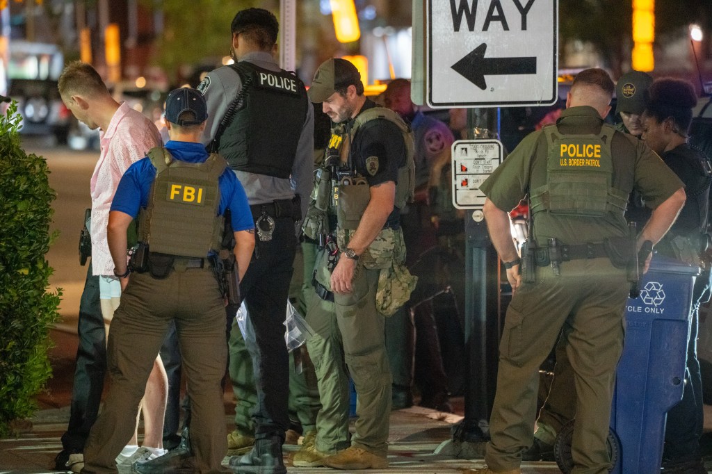 FBI, Border Patrol, and other law enforcement officers arresting a man in Washington, D.C.