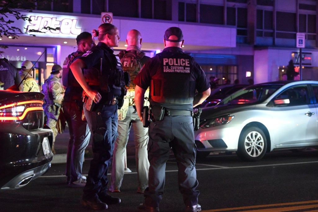 Police officers and federal agents respond to a fight near a Yotel hotel.