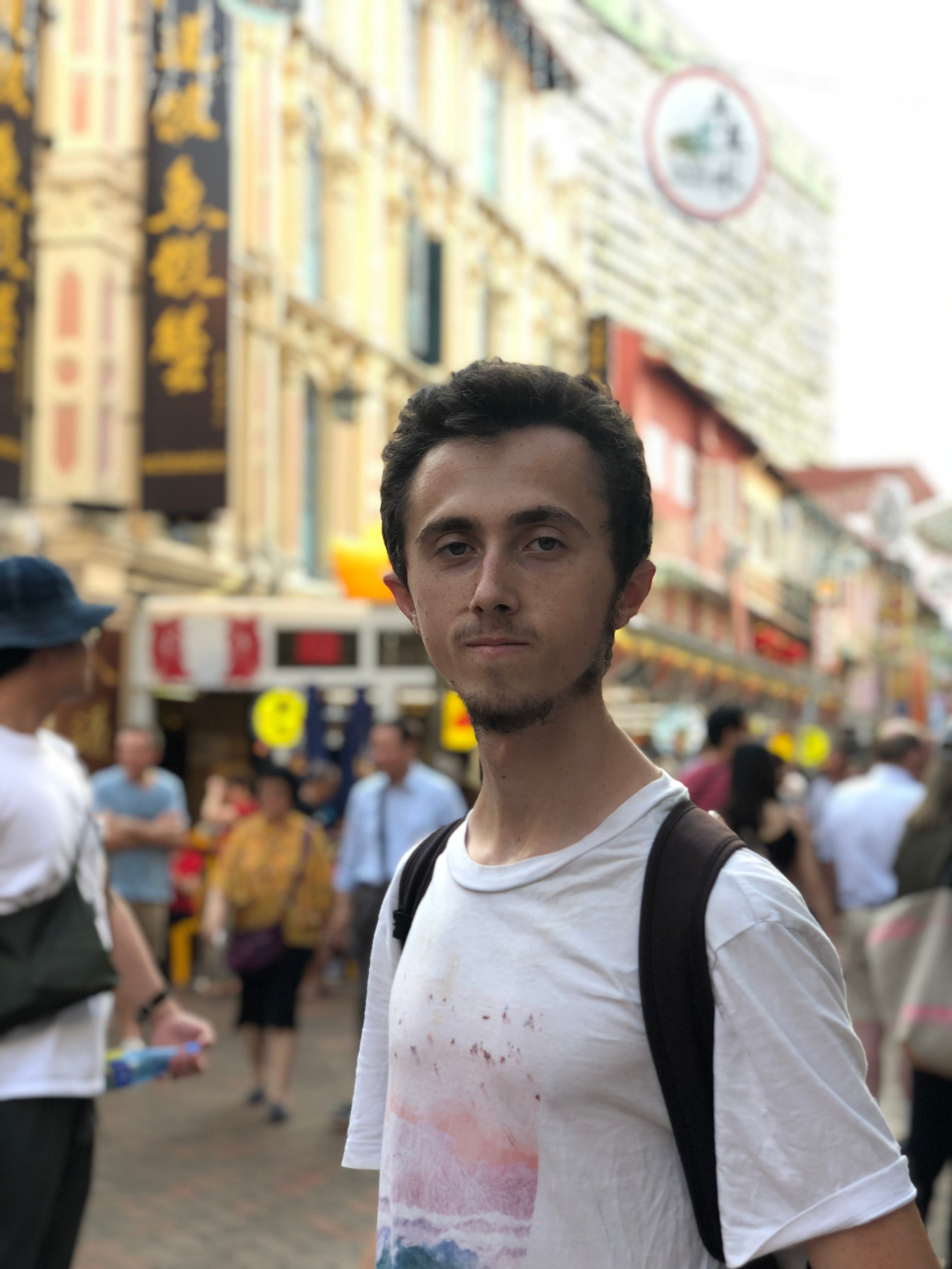 Lillywhite standing in front of shopfronts in Singapore.