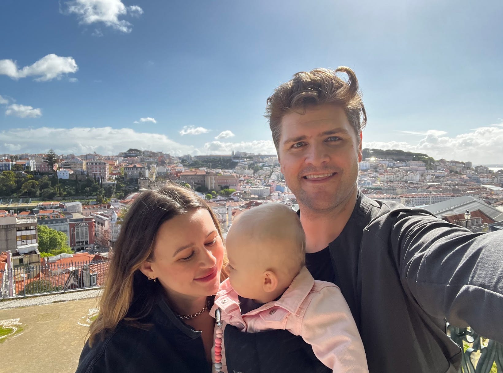 The writer, his wife, and baby posing in Portugal.